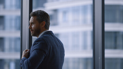 Fototapeta premium Cheerful executive celebrating success enjoying business deal by window office.
