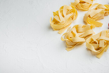 Raw pasta ingredient, on white stone table background, with copy space for text