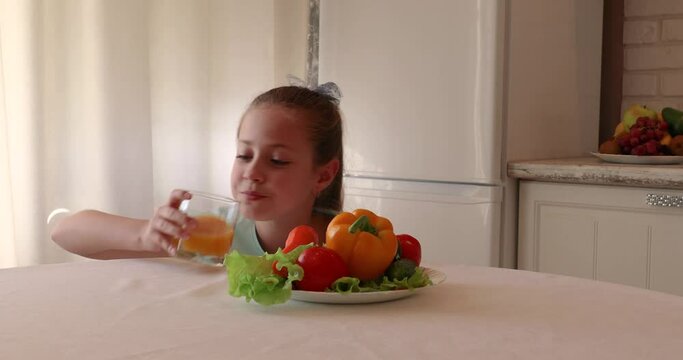 little girl in the kitchen. the child loves vegetables. healthy food concept. vitamins for a child