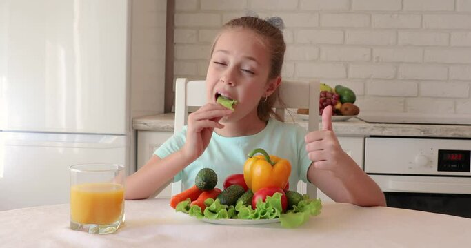 little girl in the kitchen. the child loves vegetables. healthy food concept. vitamins for a child