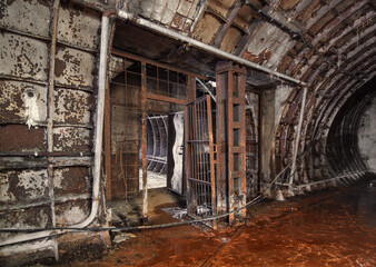 Fototapeta na wymiar Rusty passage between mines in an abandoned subway service mine