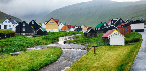 Picturesque view on village of Gjogv with typically colourful houses on the Eysturoy island, Faroe...