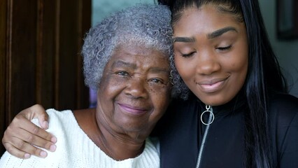 A teen granddaughter embracing grandmother a black girl embraces grandparent - Powered by Adobe
