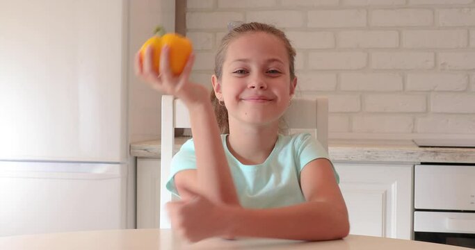 little girl in the kitchen. the child loves vegetables. healthy food concept. vitamins for a child