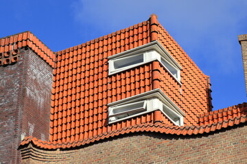 Amsterdam School of Architecture Style Roof Detail with Red Tiles and Blue Sky, Netherlands