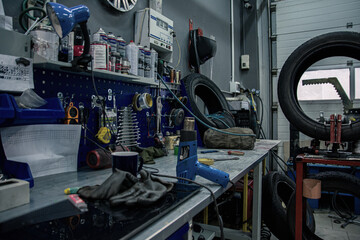 Workplace in tire service with tools and wheels