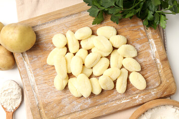 Fototapeta na wymiar Concept of cooking with raw potato gnocchi, top view