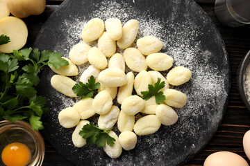 Concept of cooking with raw potato gnocchi, top view
