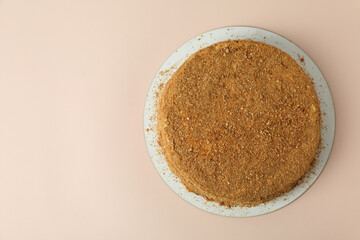 Honey cake on beige background, space for text