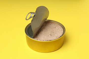 Tin of pate on yellow background, close up