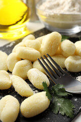 Concept of cooking with raw potato gnocchi, close up