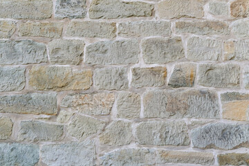 Detail einer wunderschönen alten rustikalen Wand oder Mauer aus hellen Steinen und breiten Fugen...