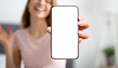 Unrecognizable young woman holding smartphone with empty screen