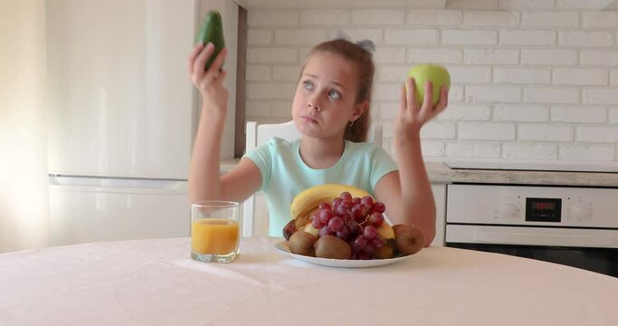 little girl wants to eat vegetables and fruits. the child enjoys fresh fruits and vegetables. girl showing thumbs up. copy space