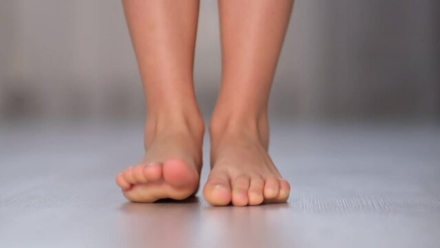 child rolls from heel to toe. Prevention of flat feet in children. Exercises for the legs. Flat feet physical therapy. close up Shot video. Slow motion