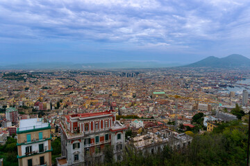 Panoramic view of Naples with Vesuvius in the background, the sky with clouds.