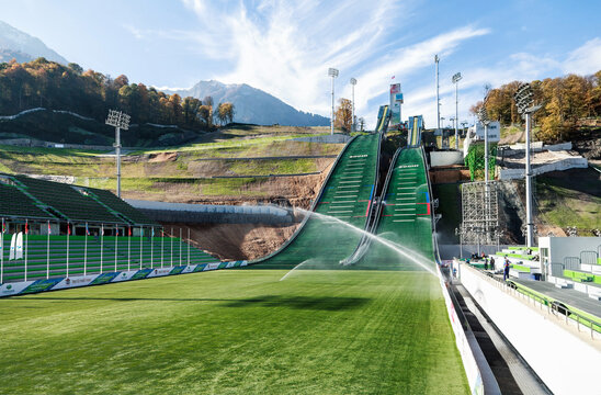 Sochi, Russia - October 13, 2013: Ski Jumping At The 2014 Winter Olympics Was Held At The RusSki Gorki Jumping Center, Krasnaya Polyana. Scenic Front View Of Ski Jumps On Sunny Summer Day