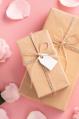 Valentine's Day design concept background with pink rose flower and gift on pink background.