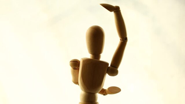 a wooden man whirls in place. dancing puppet