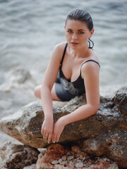 lifestyle swimwear photo-shoot of beautifaul woman on rocky beach