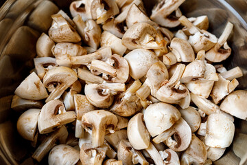 Background of champignons mushrooms slices.