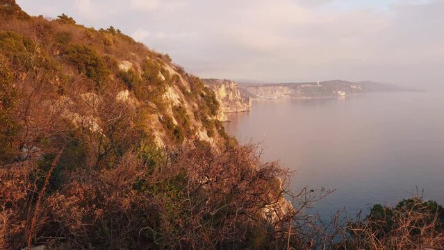 Duino cliffs and Adriatic coastline during a winter sunset near Trieste, Italy