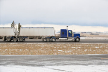 Heavy Cargo on the Road. A truck hauling freight along a highway. Taken in Alberta, Canada