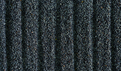 Poppy seeds close-up as a background. Spices. Seasoning for dishes. Additive ingredient for the preparation of delicious delicacies. Opium Poppy