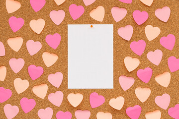 Bulletin board with heart-shaped stickers and a central white paper