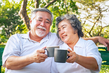 Happy asian elderly couple drink coffee relax in park, relationship retirement, People lifestyle concept.