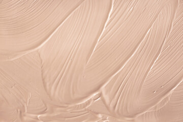 A smear of foundation as a background. The texture of cosmetics for the face. Foundation.