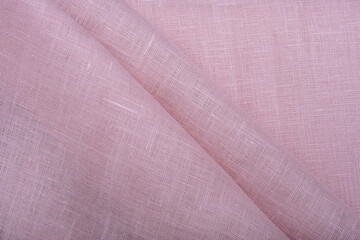 Natural linen fabric texture. Textured rose fabric background. Concept of using natural eco-friendly materials