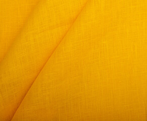 Natural linen fabric texture. Textured yellow fabric background. Concept of using natural eco-friendly materials
