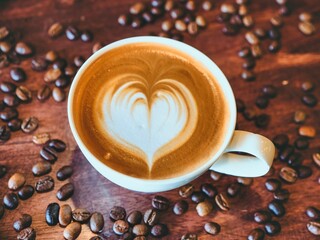 coffee latte art on wood table flat lay , relax time, cafe barista art top view.
