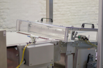 Line for the production of chocolate in an industrial factory. Automatic process in the production line of sweets. Images from the chocolate factory during production. Conveyor belt with sweets.