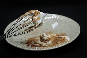 Sweet whipped cream with cocoa on a plate