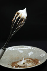 Sweet whipped cream with cocoa on a plate