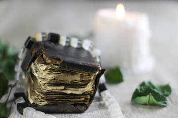 still life with old prayer book  candle and rosary on a table