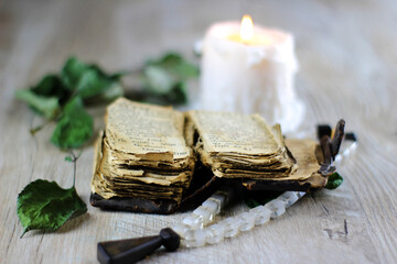 still life with old prayer book  candle and rosary on a table