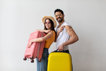 Ready for travel. Young vaccinated couple showing shoulders with band aid after Covid-19 vaccine,...