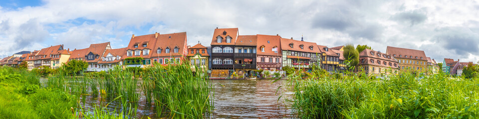 Fototapeta na wymiar Traditional buildings at the Regnitz river in the historic old town of Bamberg, a medieval city in Upper Franconia, Germany. Famous travel, tourism destination