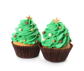 Tasty Christmas tree cupcakes on white background