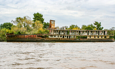 The long-abandonned rusting hulk of a river steamer lies in the Tigre delta near Buenos Aires in...