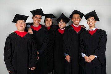 Group of graduate students friends pose together excitedly laughing only male