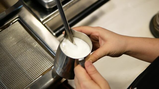 Barista Making Hot Milk Foam By Using The Heat From The Machine