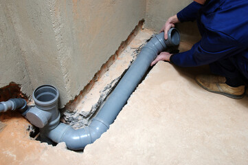 Plumber assemble pvc sewage pipes.