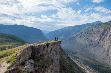 tourists on the edge of a cliff. Katu-Yaryk. Altai mountains