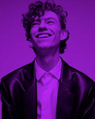 Portrait photo of a smiling curly guy.looking up.wearing a black jacket and a white shirt
