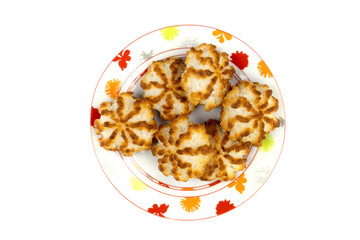 homemade coconut cookies in a plate on a background