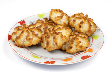 homemade coconut cookies in a plate on a background